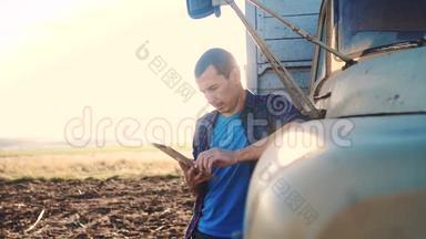 智慧<strong>农业</strong>。 男子农民司机站在卡车附近的<strong>数字</strong>平板电脑。 肖像商人农民站在